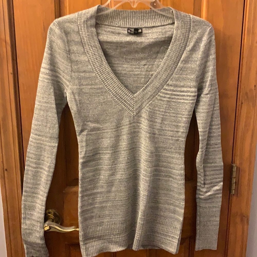 Express silver/gray deep v-neck slim fitting sweater has shiny material